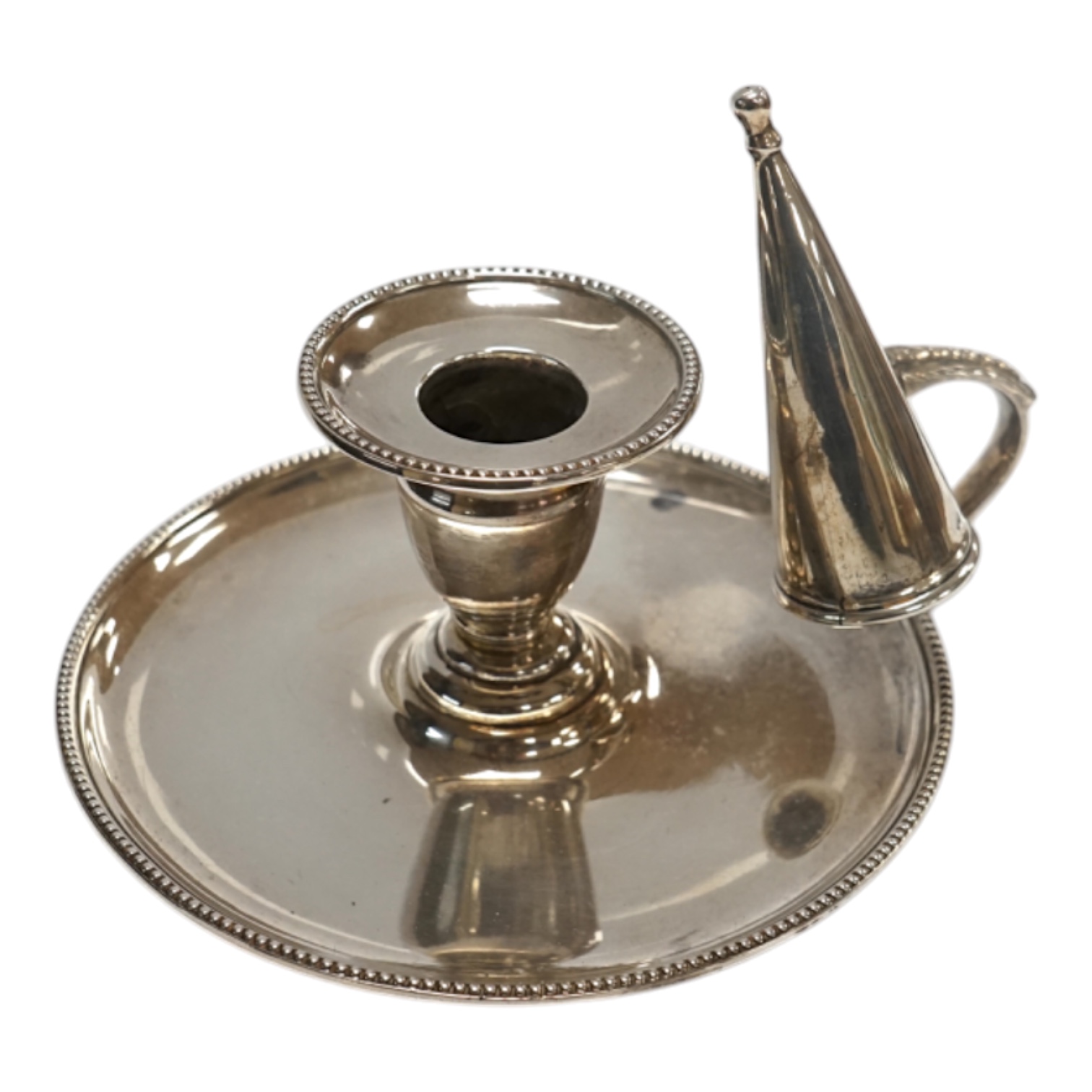 A Victorian silver chamberstick, Walker Knowles & Co, Sheffield, 1859, with later associated silver extinguisher, diameter 13.2cm. Condition - fair